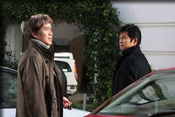 商社マン藤井(佐藤浩一)